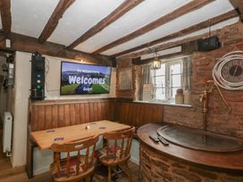 A dining room with a television and a bar at Penny Farthing Inn Aston Crews near Ross-On-Wye