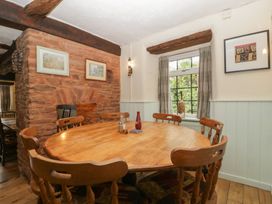 A dining room with a wooden table and chairs at Penny Farthing Inn Aston Crews near Ross-On-Wye