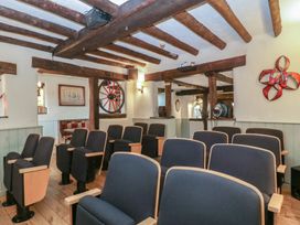 A cinema room with rows of chairs at Penny Farthing Inn Aston Crews near Ross-On-Wye