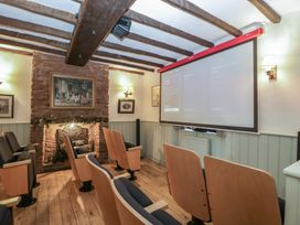 A home theater with a projector and seating at Penny Farthing Inn Aston Crews near Ross-On-Wye