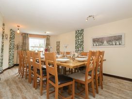 A dining room with a large table and chairs at Penny Farthing Inn Aston Crews near Ross-On-Wye