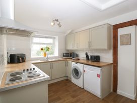 A kitchen with appliances and a window at Penny Farthing Inn Aston Crews near Ross-On-Wye