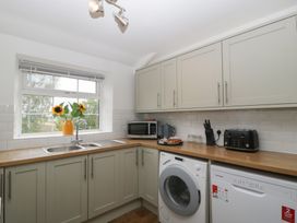 A kitchen with appliances and cabinets at Penny Farthing Inn Aston Crews near Ross-On-Wye