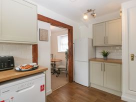 A kitchen with appliances including a dishwasher and refrigerator at Penny Farthing Inn Aston Crews near Ross-On-Wye