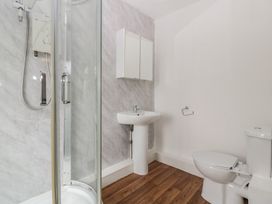 A bathroom with a shower, sink, and toilet at Penny Farthing Inn in Aston Crews near Ross-On-Wye