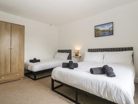 A bedroom with two beds and a wardrobe at Penny Farthing Inn Aston Crews near Ross-On-Wye