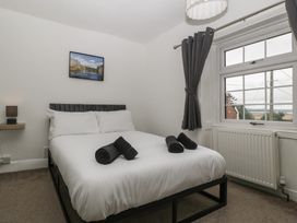 A bedroom with a bed and lamp at Penny Farthing Inn Aston Crews near Ross-On-Wye