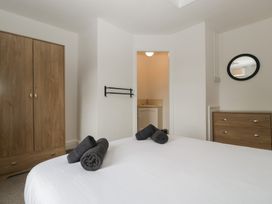 A bedroom with a bed and wardrobe at Penny Farthing Inn Aston Crews near Ross-On-Wye