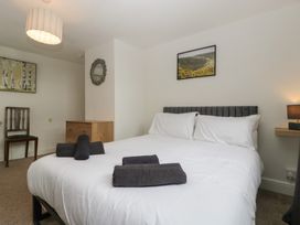 A bedroom with a bed and wall art at Penny Farthing Inn Aston Crews near Ross-On-Wye