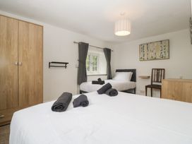 A bedroom with beds and a wardrobe at Penny Farthing Inn Aston Crews near Ross-On-Wye