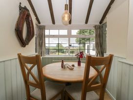 A dining room with a round table and chairs at Penny Farthing Inn Aston Crews near Ross-On-Wye