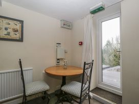 A dining area with a round table and chairs at Penny Farthing Inn Aston Crews near Ross-On-Wye