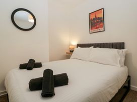 A bedroom with a bed and wall art at Penny Farthing Inn Aston Crews near Ross-On-Wye