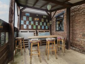 An outdoor seating area with a table and stools at Penny Farthing Inn Aston Crews near Ross-On-Wye