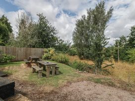 A garden with a table and benches at Penny Farthing Inn Aston Crews near Ross-On-Wye