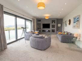 A living room with a sofa and telescope at 70 Deganwy Road in Deganwy
