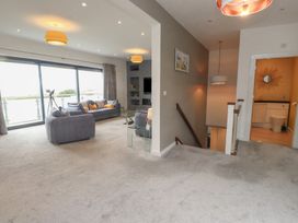 A living room with a sofa and telescope at 70 Deganwy Road in Deganwy