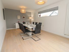 A dining room with a table set for dinner at 70 Deganwy Road in Deganwy