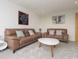 A living room with two sofas and a coffee table at 70 Deganwy Road in Deganwy