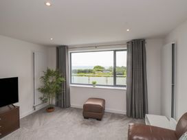 A living room with a television and sofa at 70 Deganwy Road in Deganwy