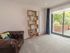 A living room with a sofa and shelf at 70 Deganwy Road in Deganwy