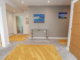 A hallway with a console table and paintings at 70 Deganwy Road in Deganwy