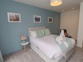 A bedroom with a double bed and armchair at 70 Deganwy Road in Deganwy