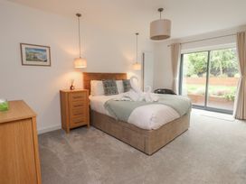 A bedroom with a bed and sliding glass door at 70 Deganwy Road in Deganwy