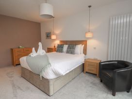 A bedroom with a bed and nightstands at 70 Deganwy Road in Deganwy