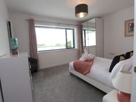 A bedroom with a bed and dresser at 70 Deganwy Road in Deganwy