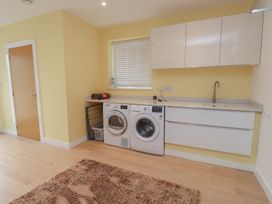 A laundry room with washer and dryer at 70 Deganwy Road in Deganwy
