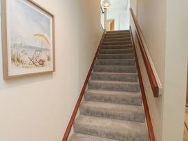 A staircase with a handrail and painting on the wall at 70 Deganwy Road, Deganwy