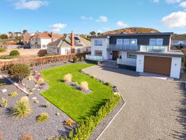 An outdoor view of a house with garden and driveway at 70 Deganwy Road in Deganwy