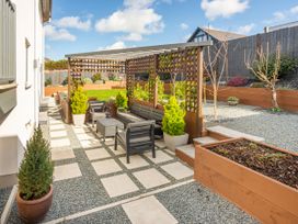 A garden with seating area and planters at 70 Deganwy Road, Deganwy
