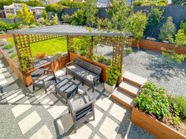 A garden with outdoor seating under a pergola at 70 Deganwy Road in Deganwy