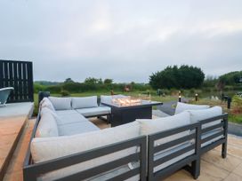 An outdoor seating area with a fire pit at The Lake Boat exclusive retreat near Black Cross