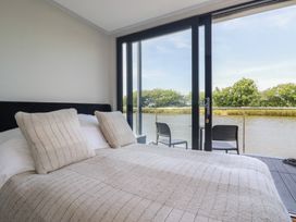 A bedroom with a bed and river view at The Lake Boat exclusive retreat Black Cross near St Columb Major