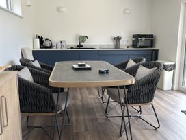 A dining room with a table and chairs at The Lake Boat exclusive retreat Black Cross near St Columb Major