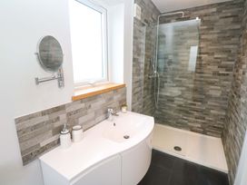 A bathroom with a shower and sink at Byron’s Retreat in Crantock