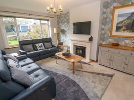 A living room with a sofa and a coffee table at Byron's Retreat in Crantock