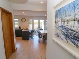 A kitchen area with a table and chairs at Byron’s Retreat in Crantock