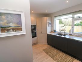 A kitchen with a sink and cabinets at Byron’s Retreat in Crantock