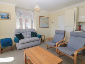 A living room with a sofa and two armchairs at Purbeck Vista in Swanage