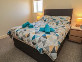 A bedroom with a bed and towels on top at Purbeck Vista in Swanage
