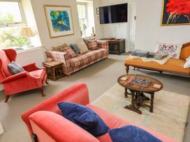 A living room with sofas and a coffee table at The Pink House Nine Wells near Solva