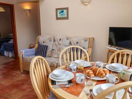 A dining area with plates and cups on a table at Churn House in Ipswich