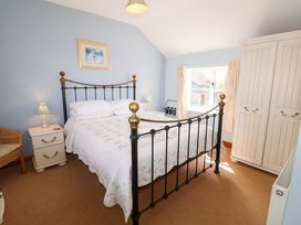 A bedroom with a bed and nightstand at Churn House in Ipswich