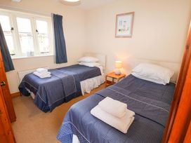 A bedroom with two beds and a lamp at Churn House in Ipswich