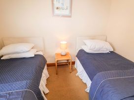 A bedroom with two beds and a lamp at Churn House in Ipswich
