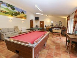 An activity room with a pool table and seating area at Churn House Ipswich